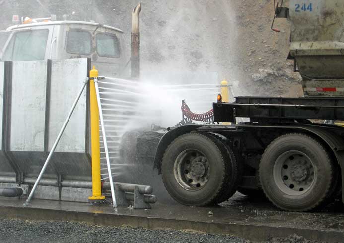 Tire and wheel wash system spraying truck.