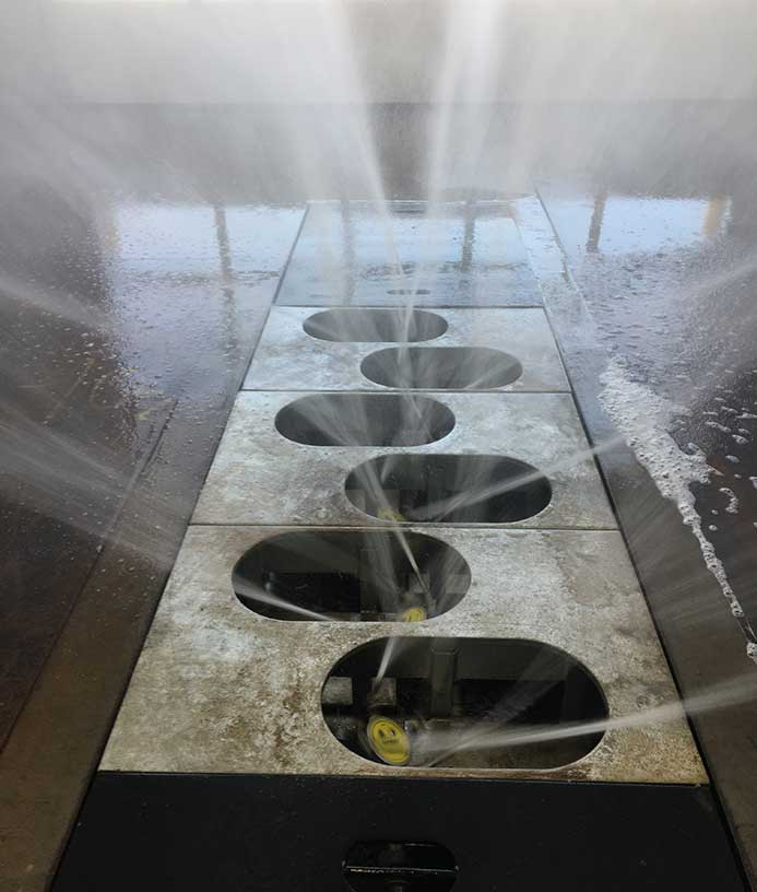 A close up of floor laid wash systems for truck tires.