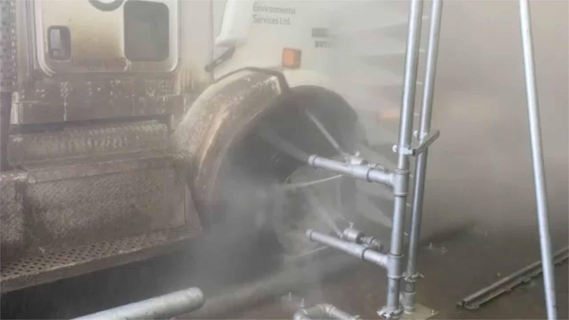 A close up of a tire being cleaned in a tire wash system.