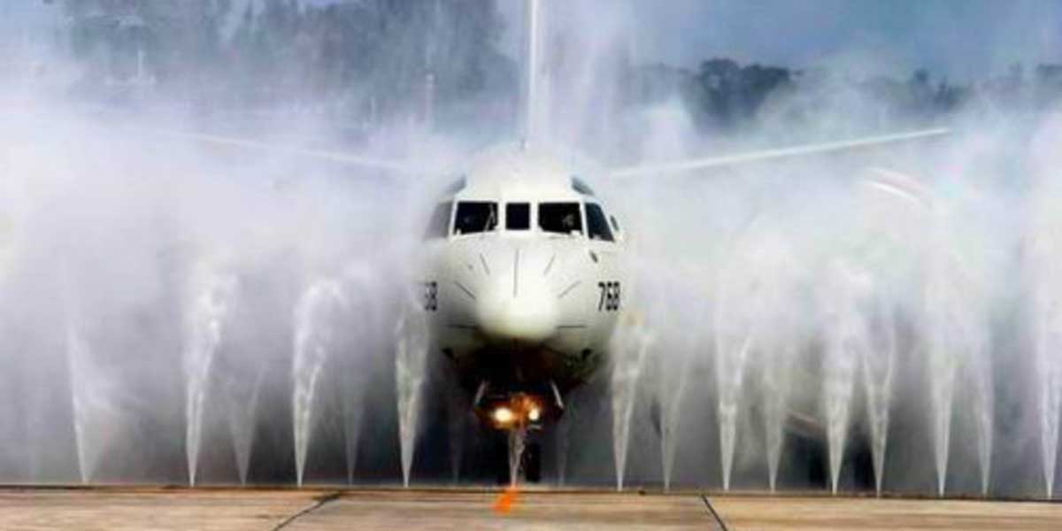 A military airplane going through a wash system.