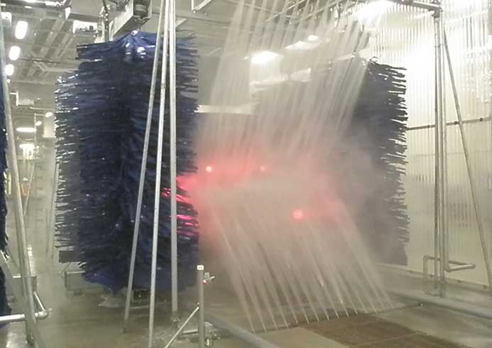 A bus going through a bus wash system.