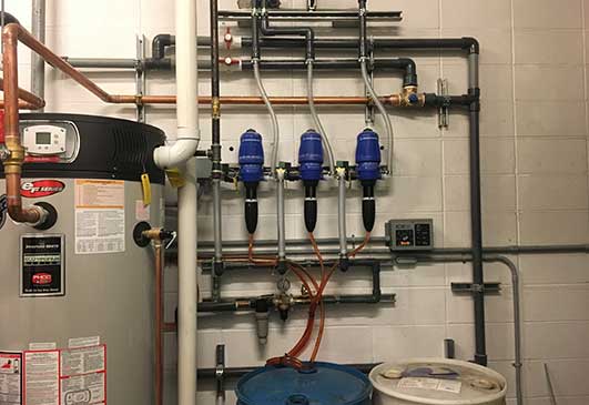 A wall with wall-mounted chemical and vehicle wash detergent dispensers.