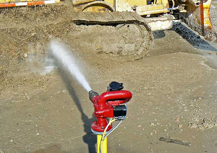 A construction vehicle being sprayed down.